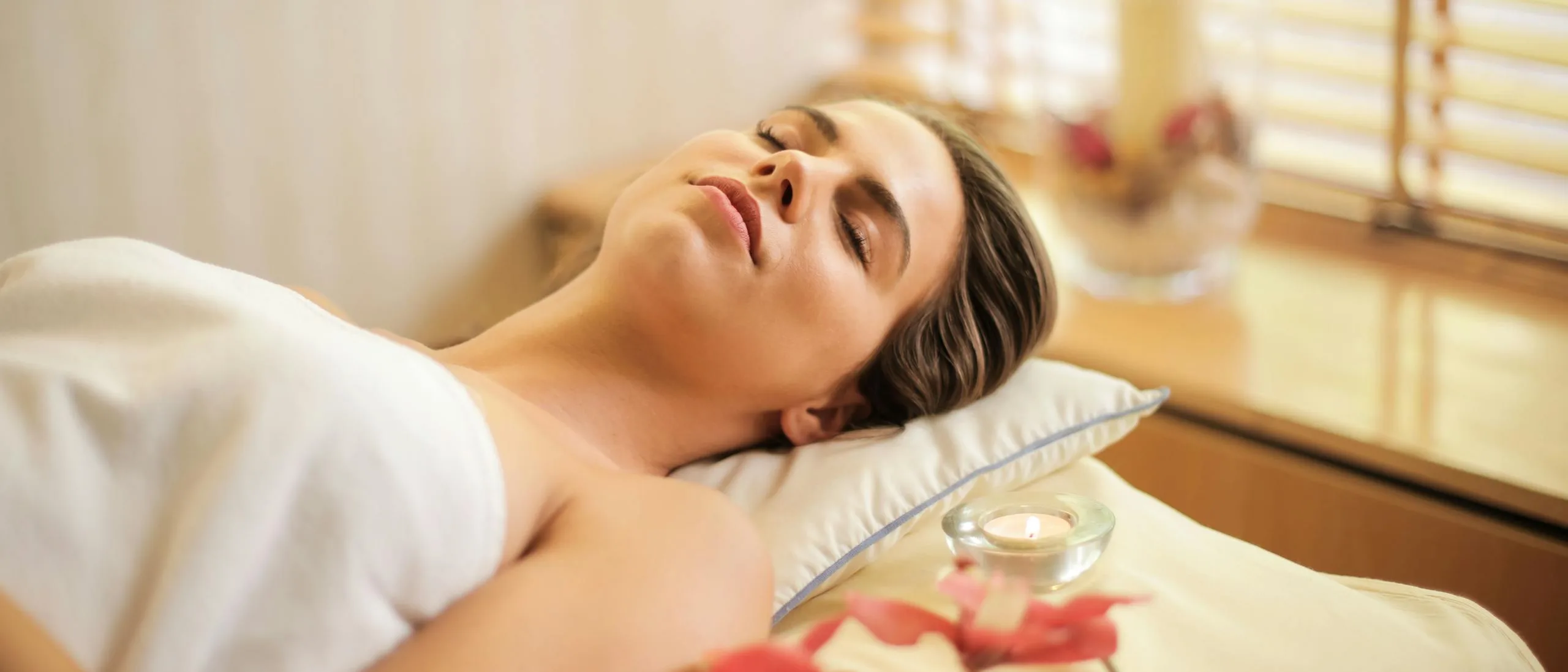 Wide view of a hot stone massage in a calm treatment room